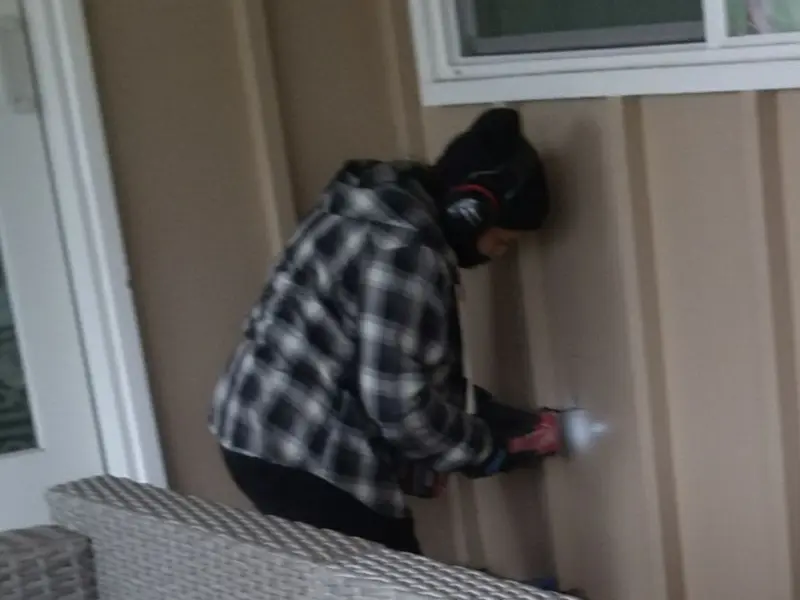 Professional electrician installing an exterior outlet in Proctor